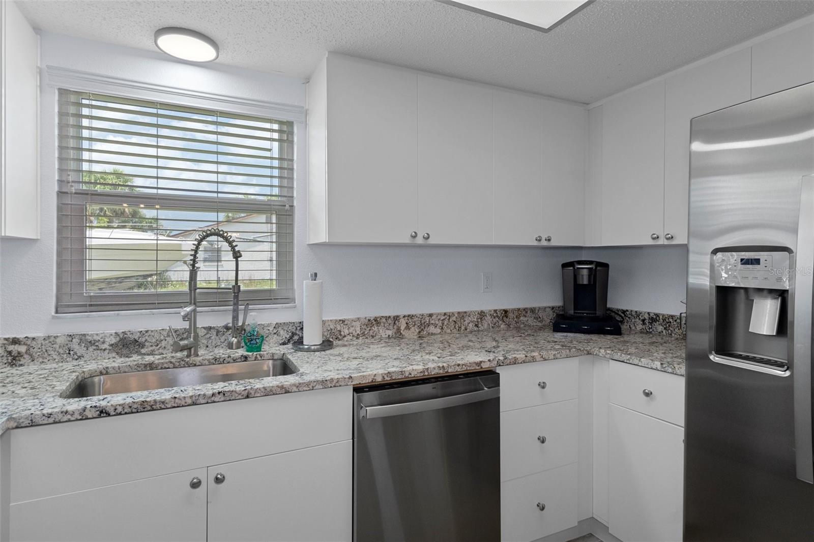 Kitchen with Granite Tops and Self Closing Cabinetry