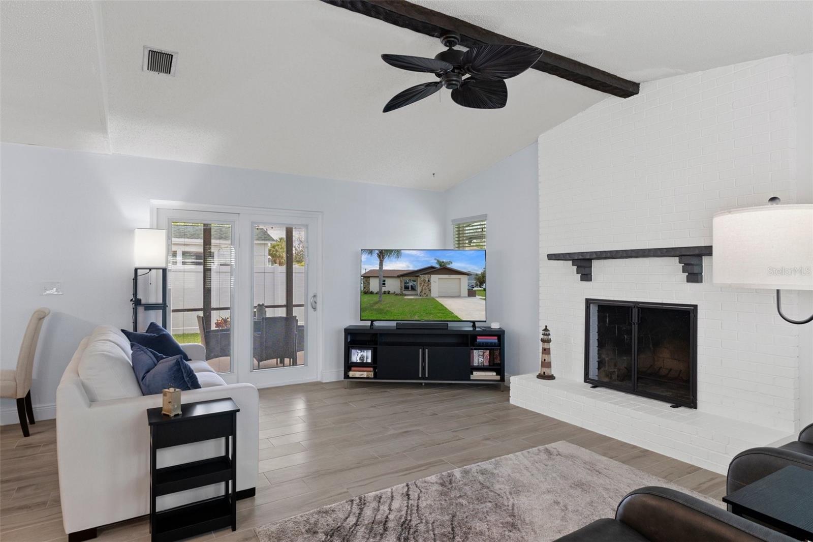 Family Room with Wood Burning Fireplace and NEW Wood Look Tile Plank Flooring