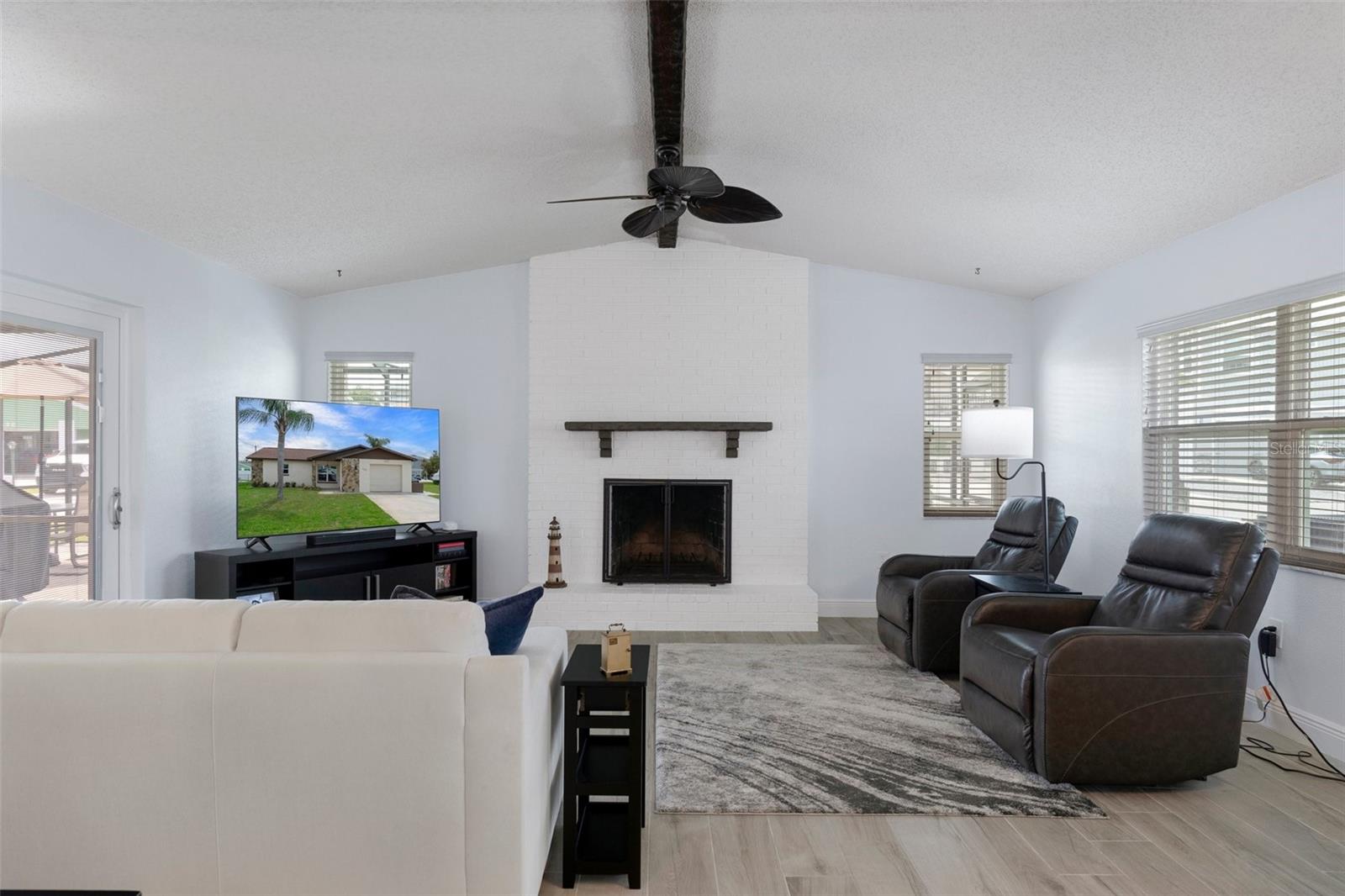 Family Room with Wood Burning Fireplace and NEW Wood Look Tile Plank Flooring