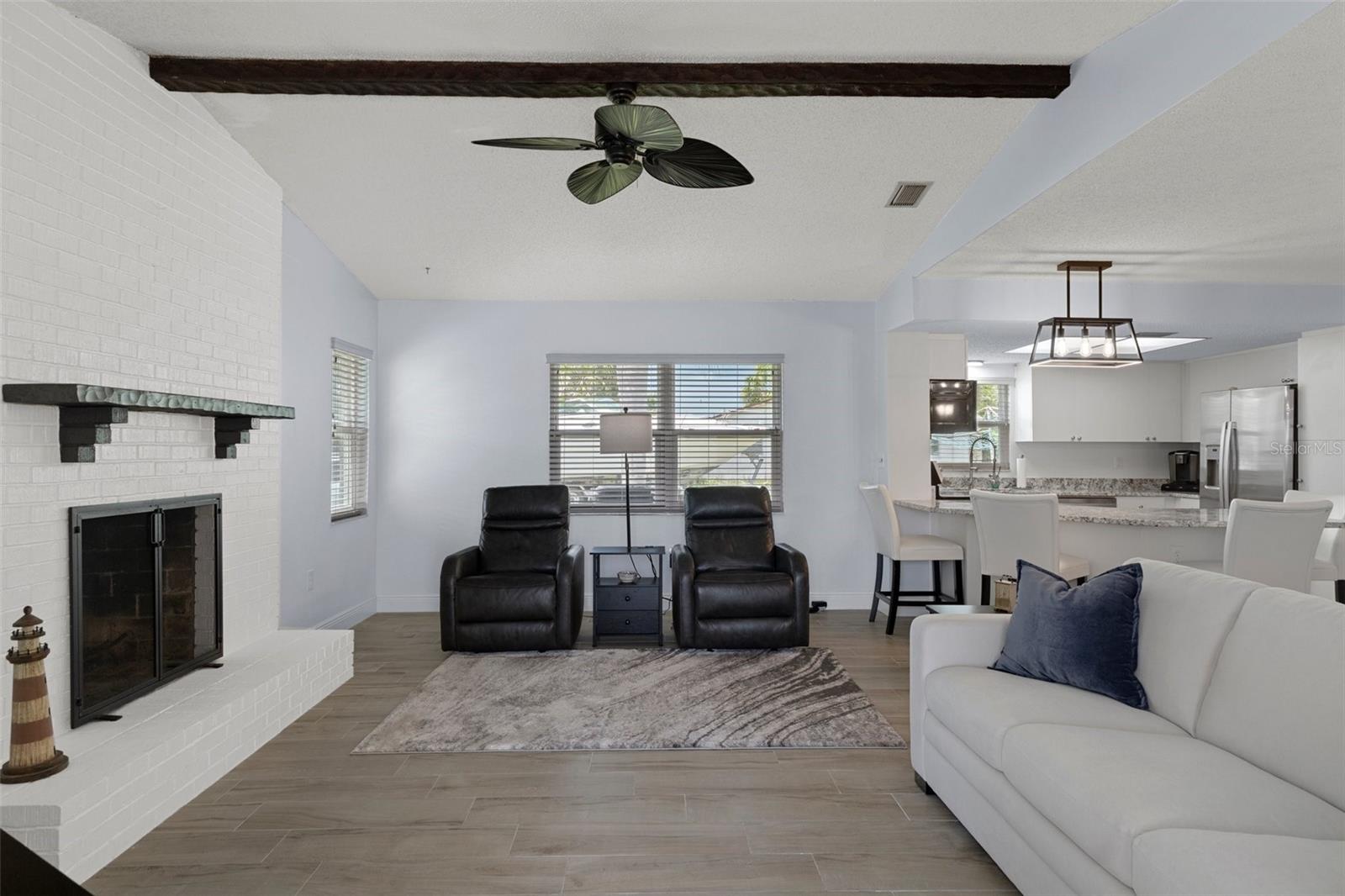 Family Room with Wood Burning Fireplace and Wood Ceiling Beam