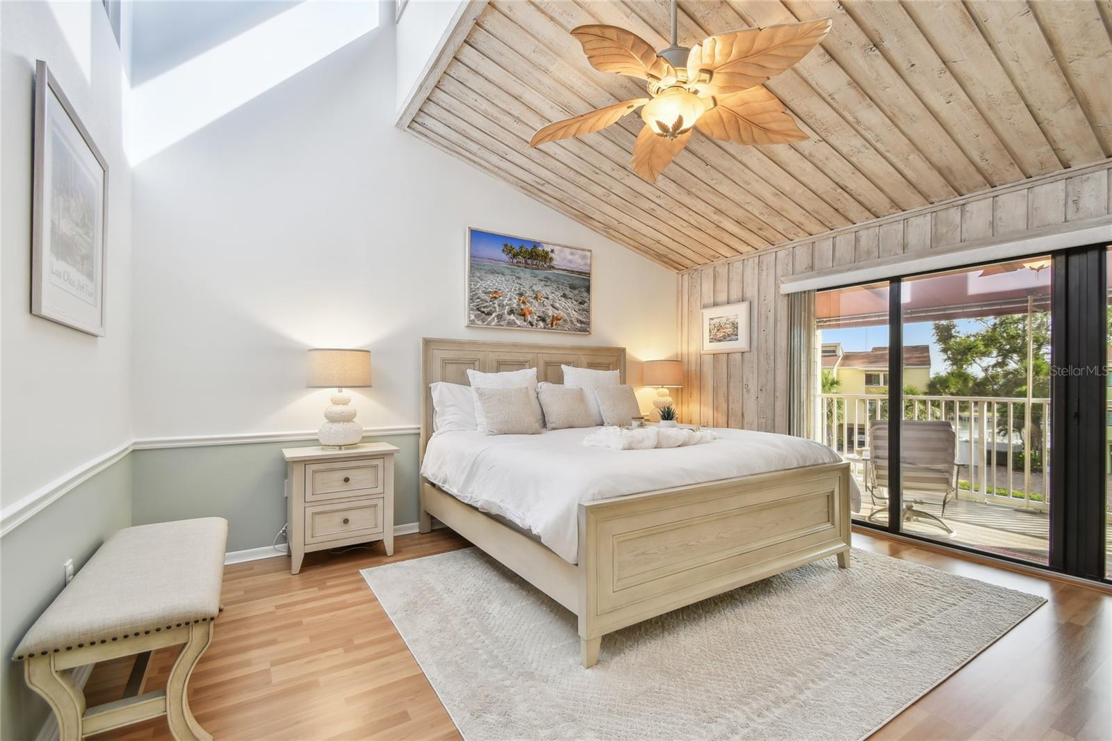 Escape to the primary bedroom with clerestory windows capturing natural light and a private covered balcony.