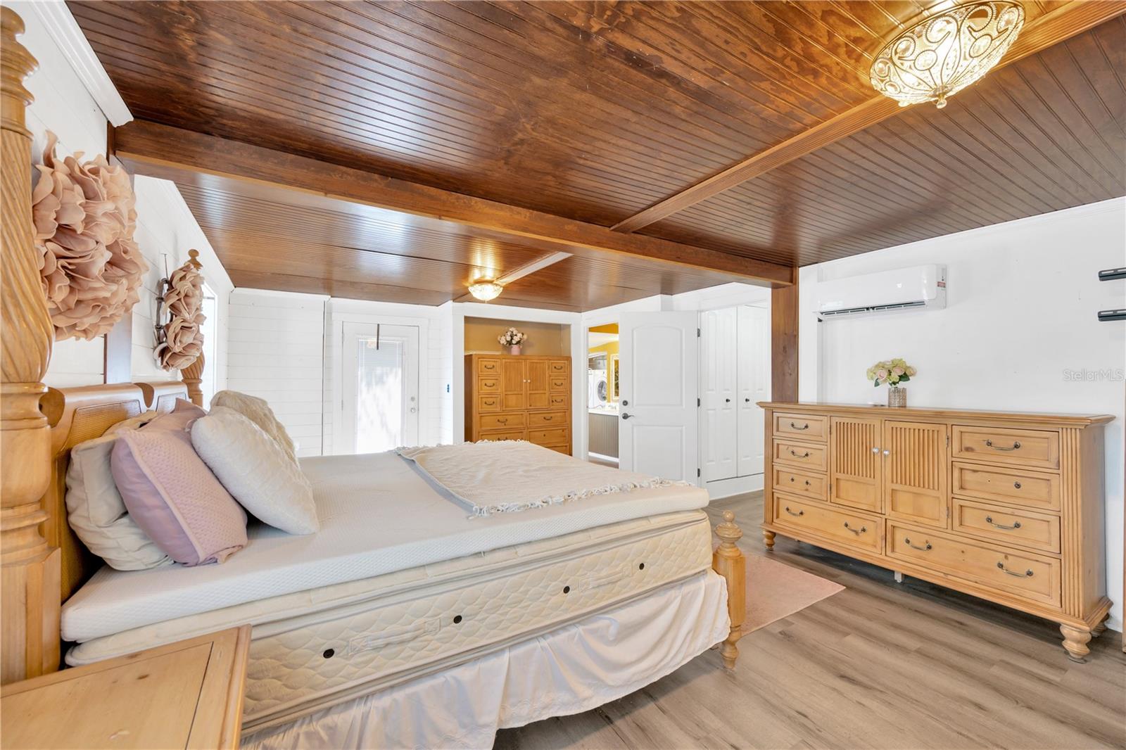 The private primary suite is a retreat unto itself, complete with an impressive 12' x 14' walk-in closet, an en-suite bathroom, and private exterior access to the private backyard.