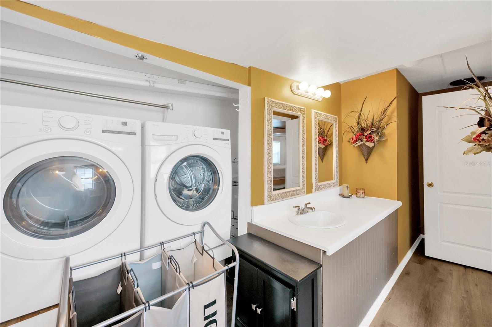 This a full sized washer & dryer tucked inside a closet inside the primary bathroom.