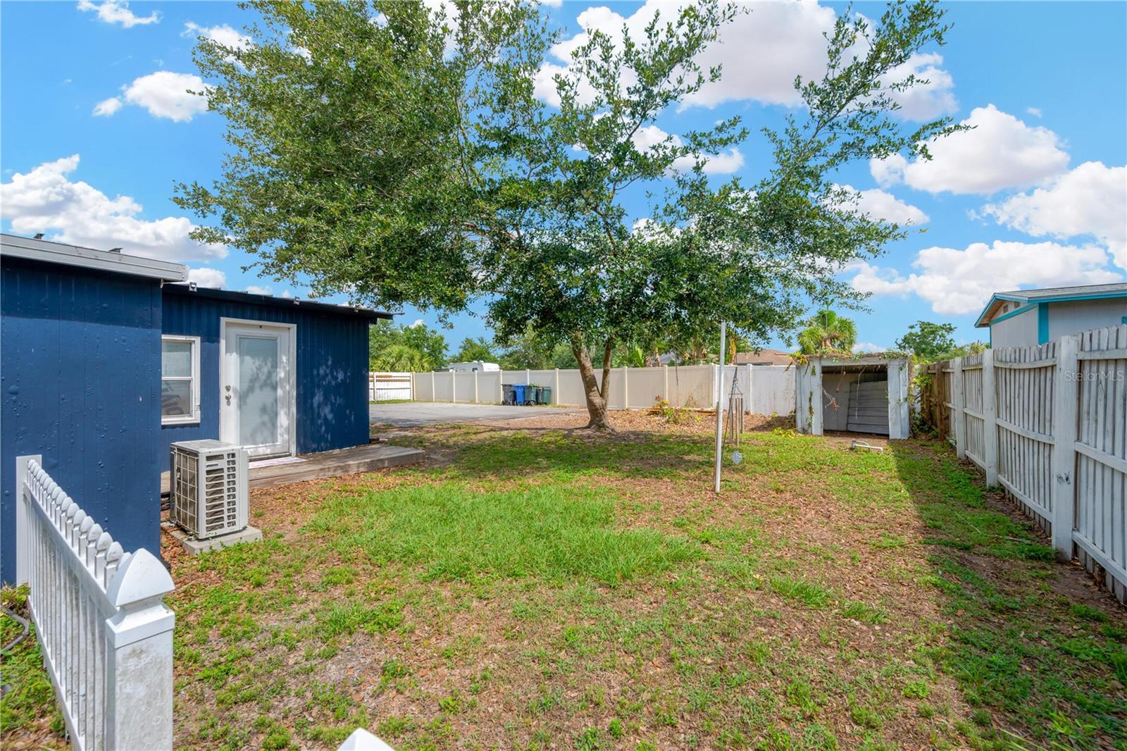 Side yard and exterior entrance and deck into the primary suite.