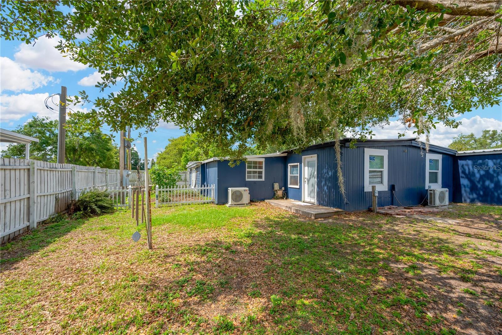 View of home from backyard. Exterior upgrades include durable metal roof, Hardie board siding, and 8" thick exterior walls.