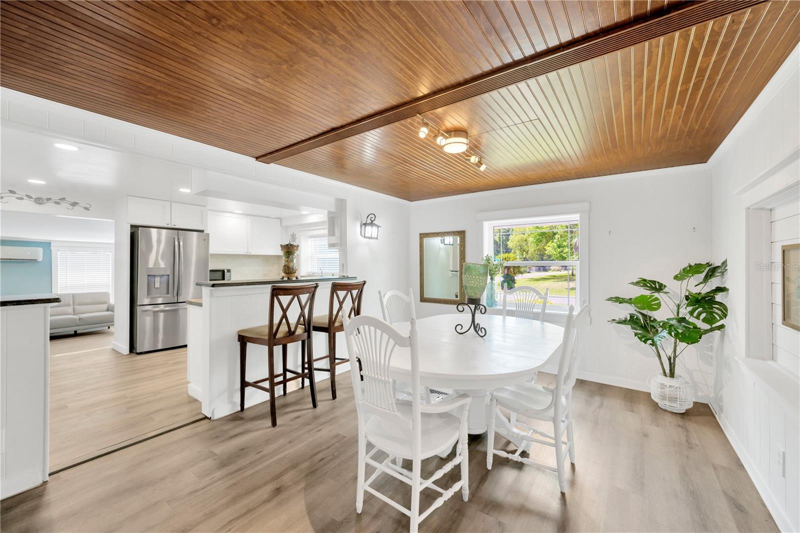 A granite breakfast bar provides extra seating and flows seamlessly into the spacious dining and living room.