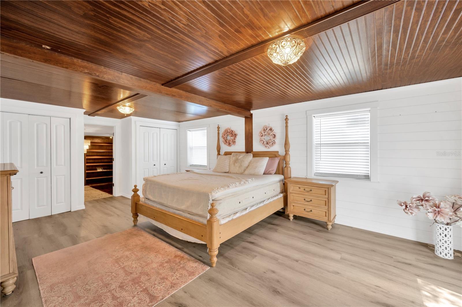 Primary suite is a retreat unto itself, complete with an impressive 12' x 14' walk-in closet, an en-suite bathroom, and private exterior access to the private backyard.