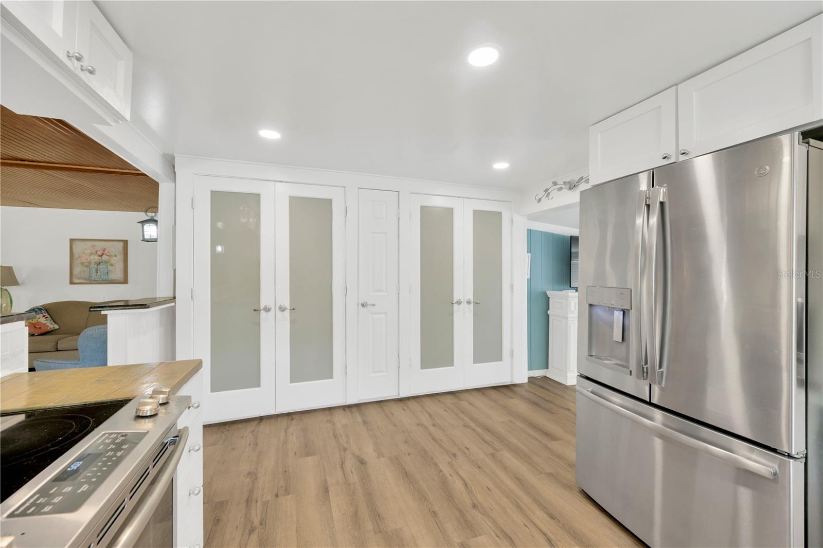 Two custom-built pantries and a central broom closet offer exceptional storage.