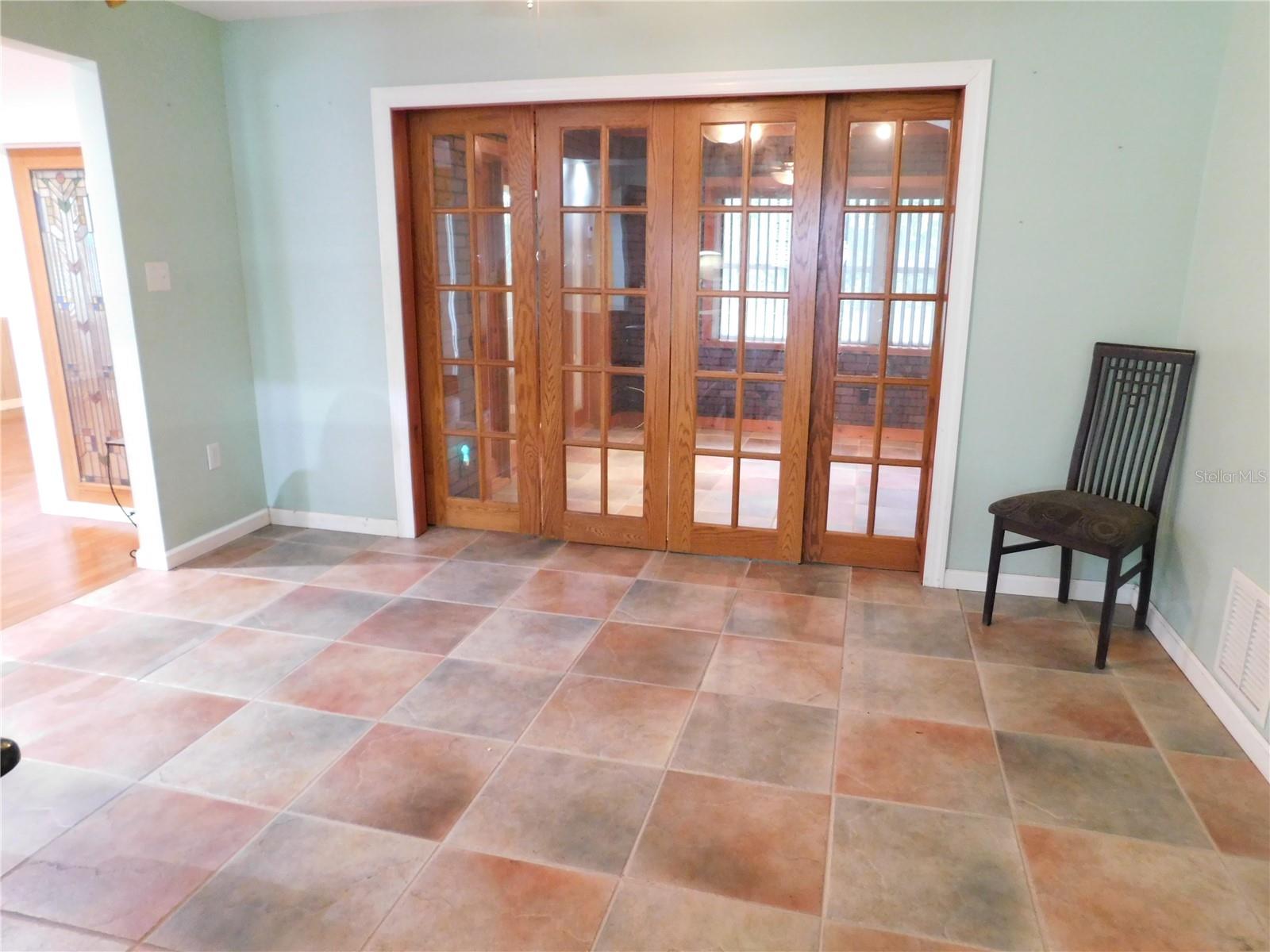 Breakfast area with tile floors and sliding french doors