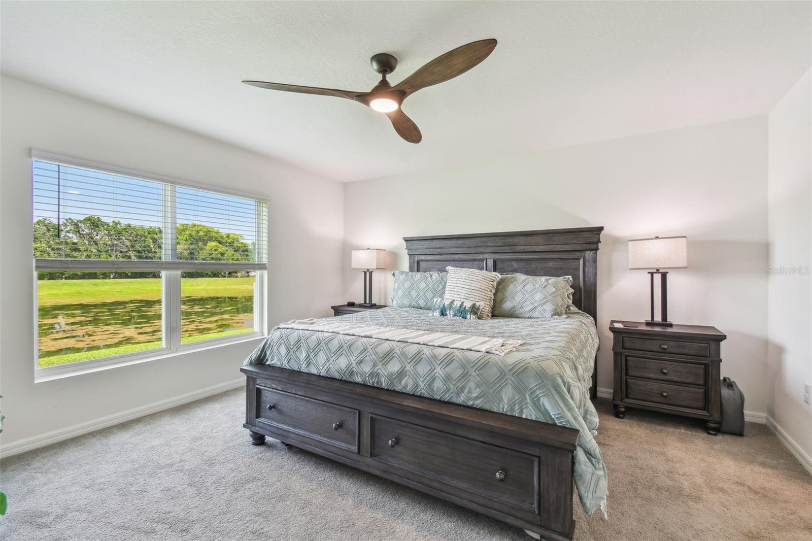 PRIMARY BEDROOM WITH SPECTACULAR POND VIEW