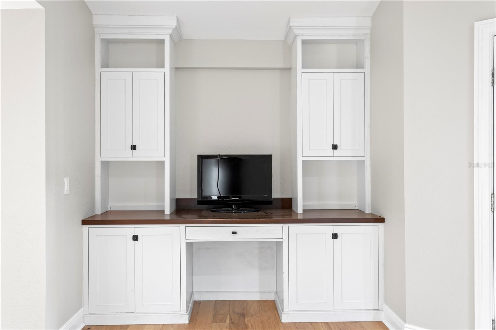 The primary bedroom includes built-ins, perfect for a home office setup