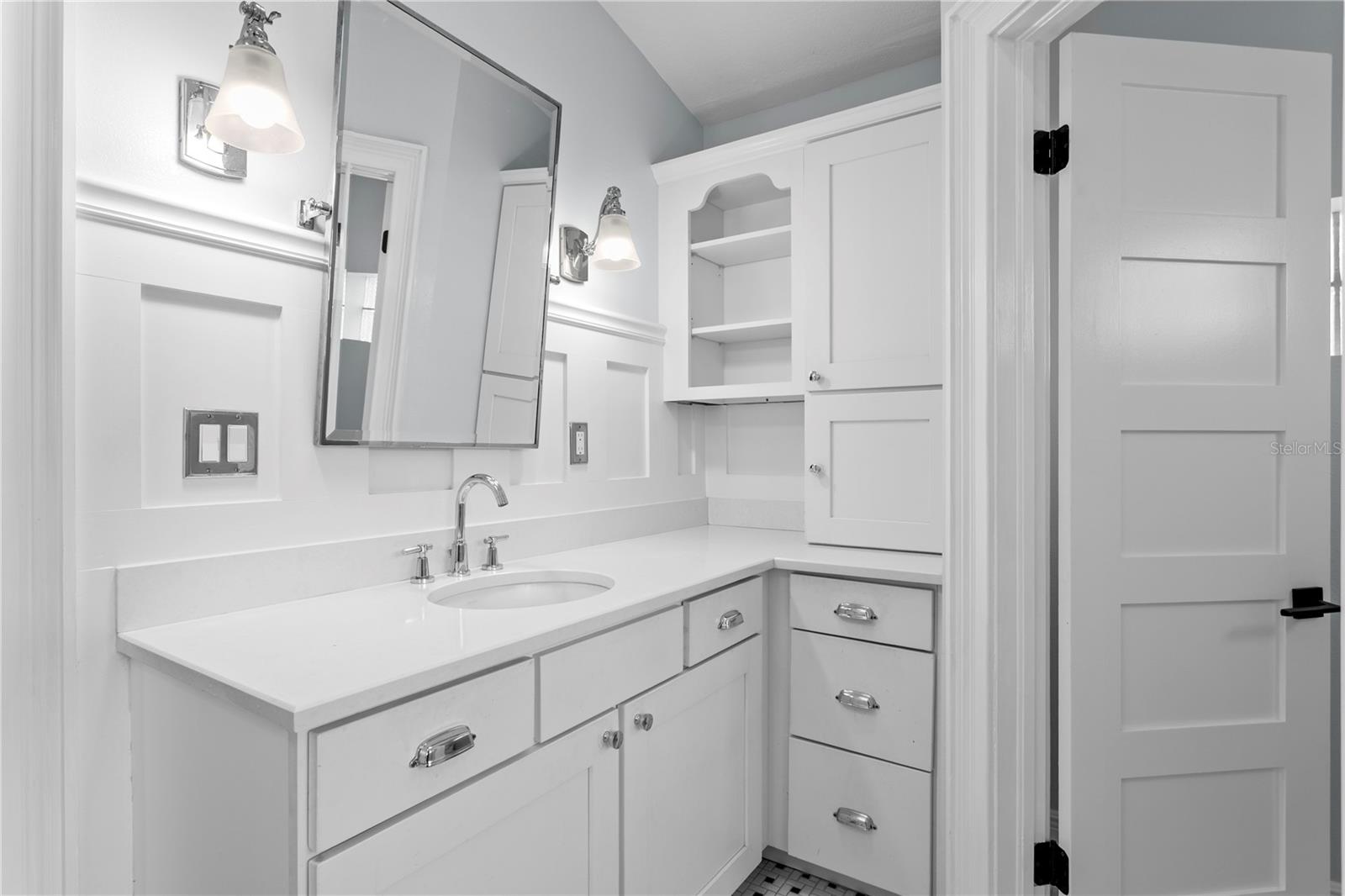 The primary bathroom features dual vanities...