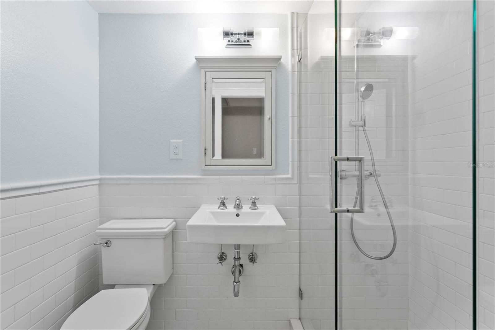 A full bathroom is located off the hallway for guests or the third bedroom to access