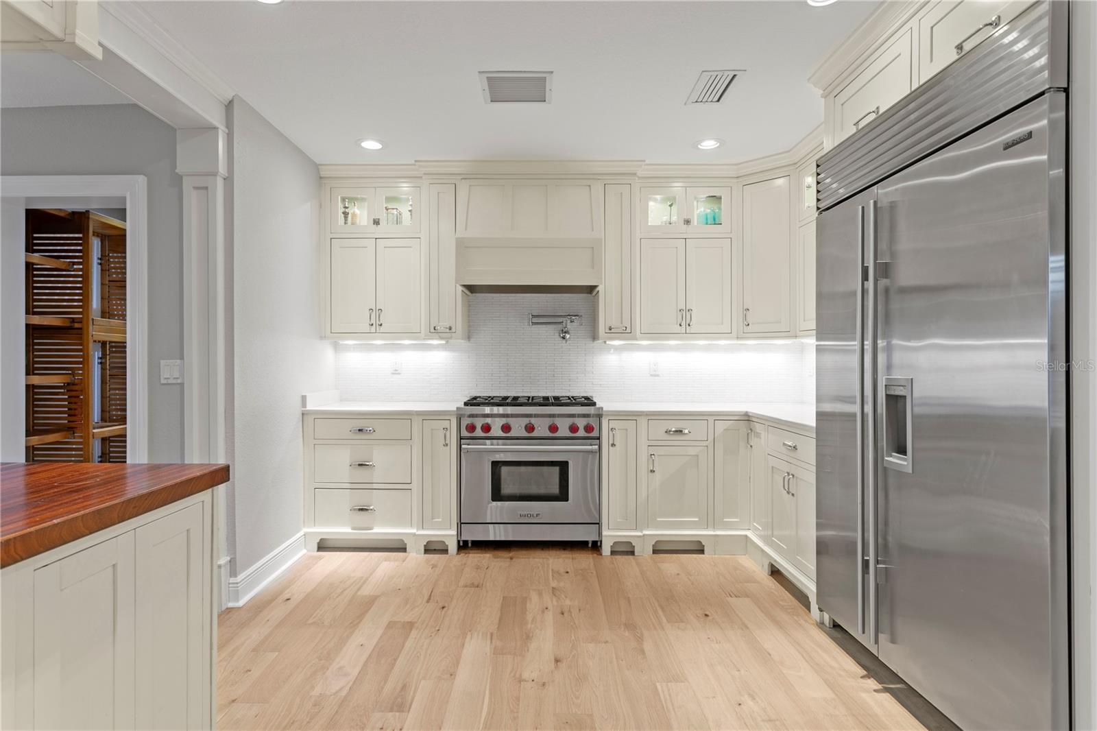 The kitchen includes high-end Sub-Zero and gas Wolf appliances