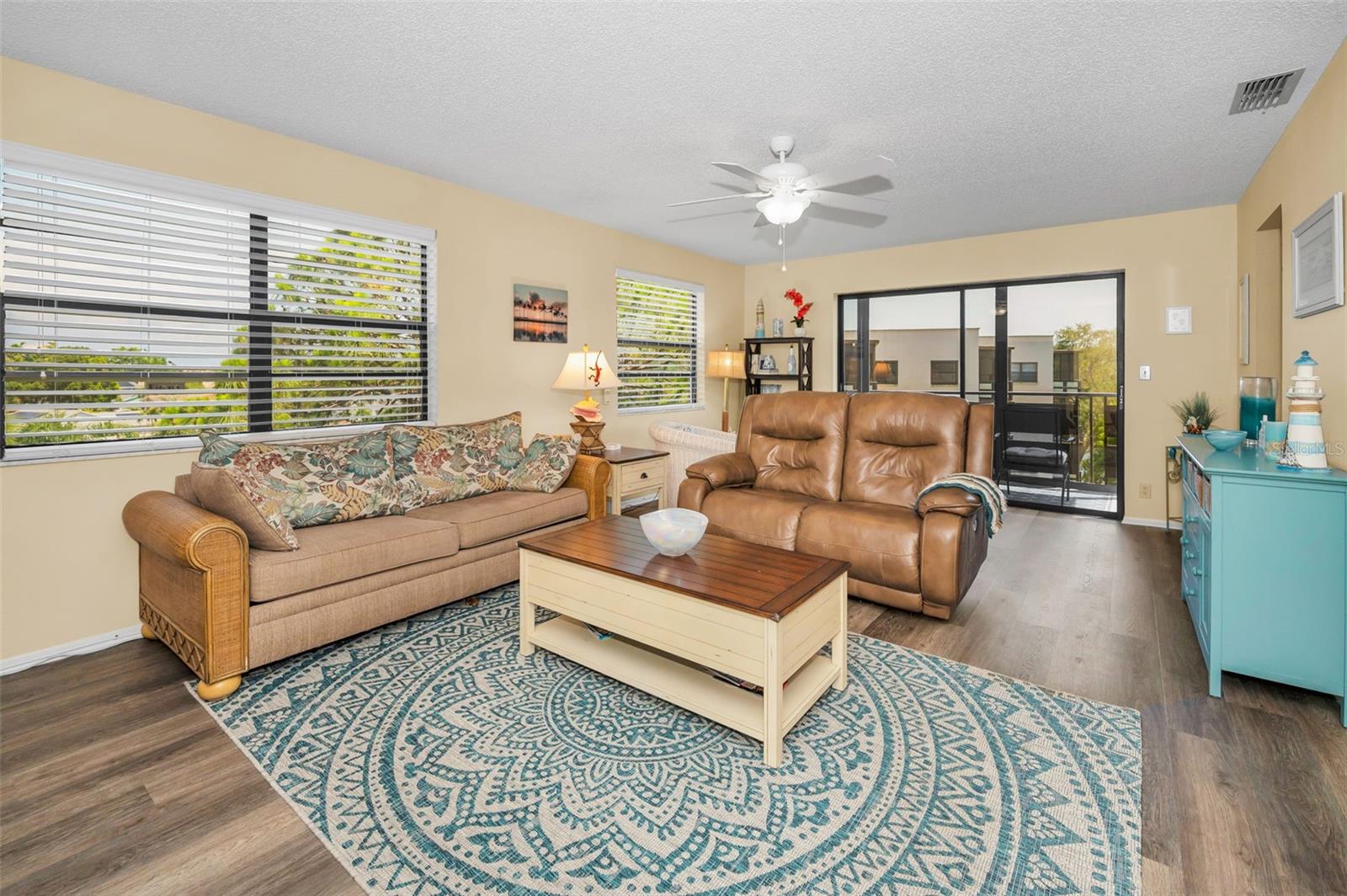 Living room with luxury vinyl and sliders to the balcony