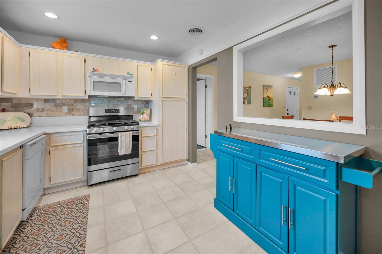 Kitchen is open to the dining room with pass thru window