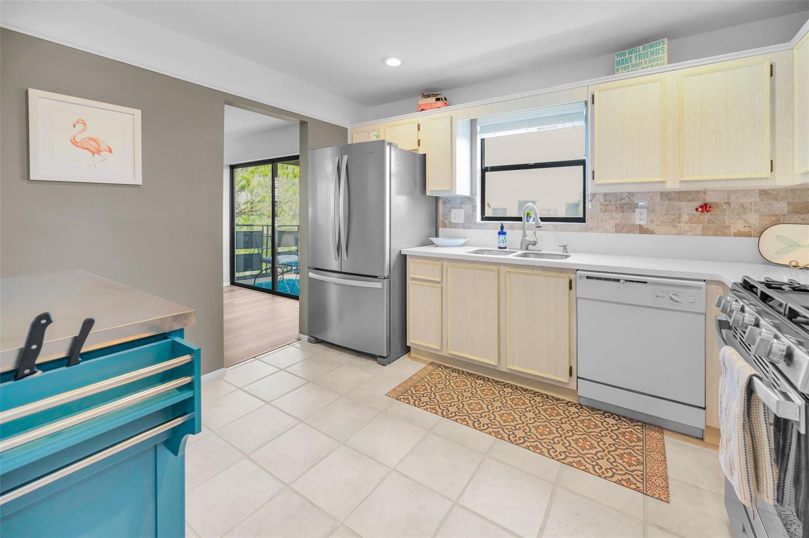 Kitchen is open to living room and balcony access