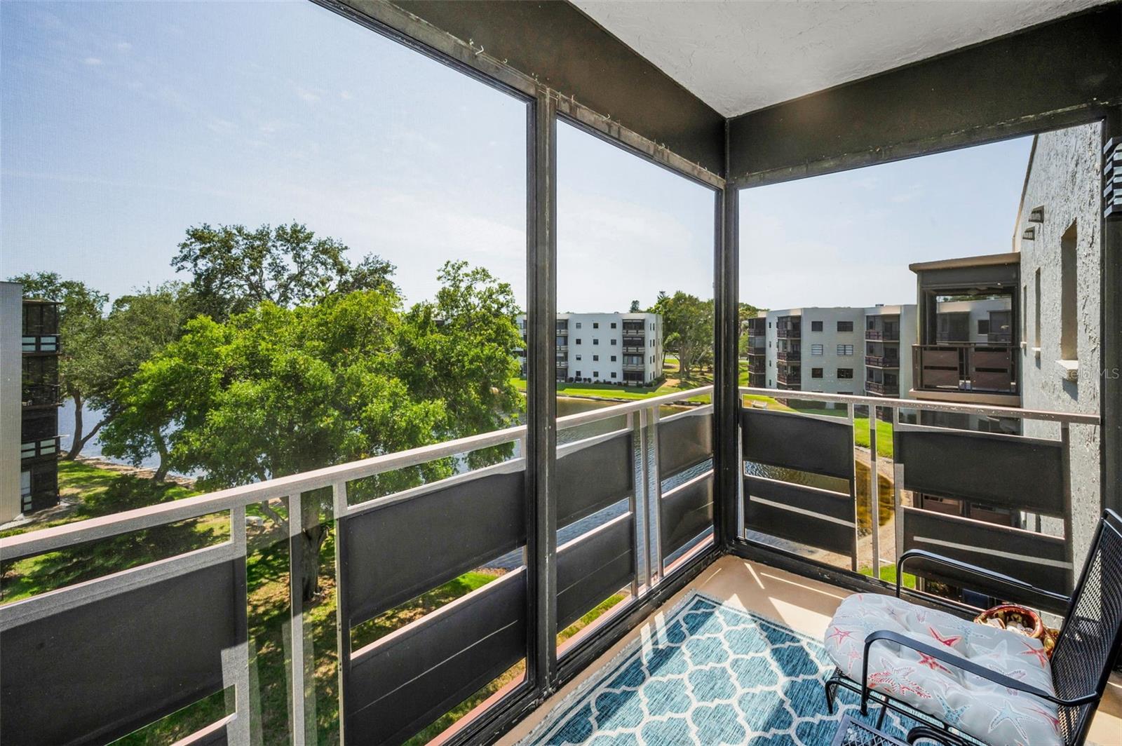 Screen enclosed balcony with great views of the pond