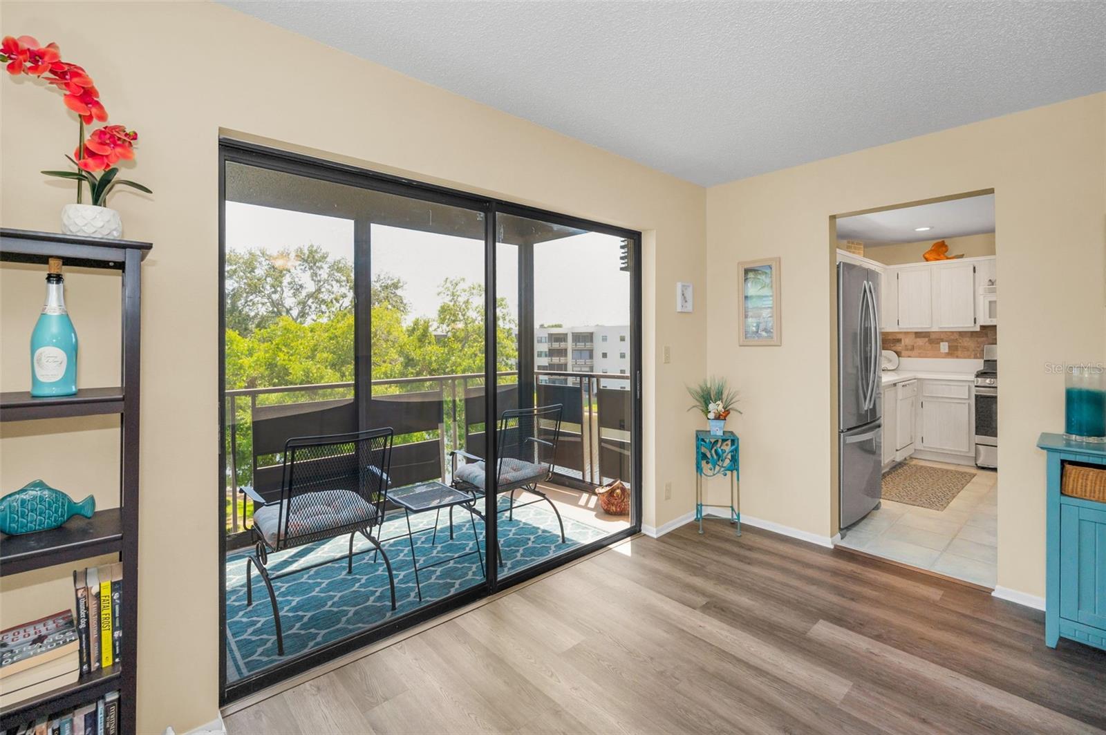 Living room with views of balcony and pond
