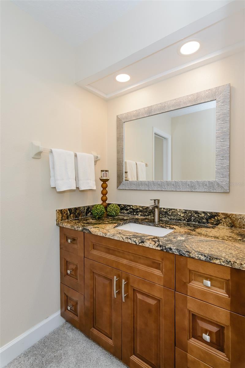 Primary bath with solid wood soft-close cabinetry and granite countertop with undermount sink.