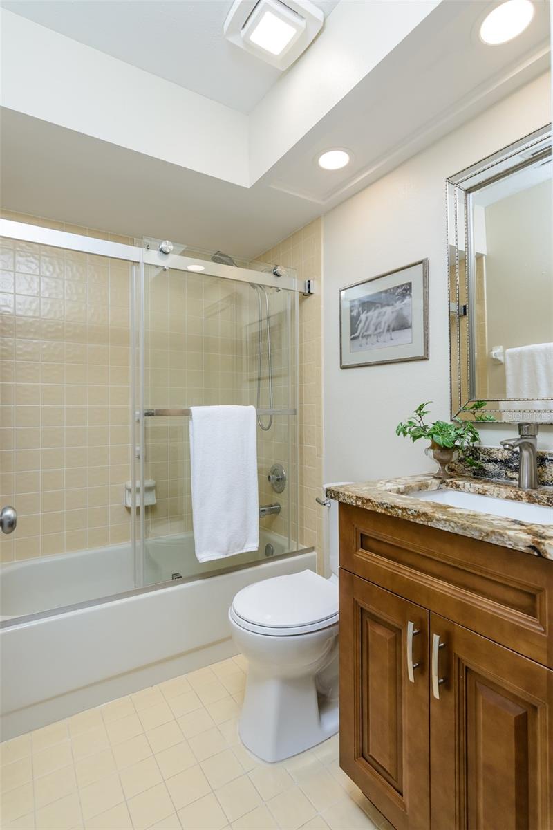 Guest bath with soft-close solid wood cabinetry and granite countertop with undermount sink.