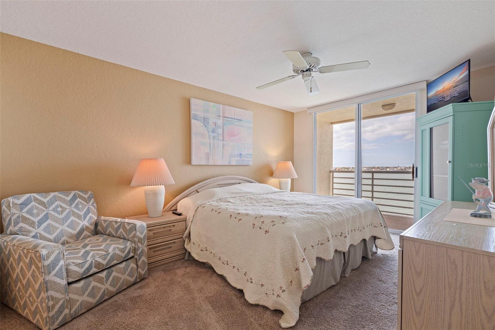 Primary bedroom with private waterfront balcony.