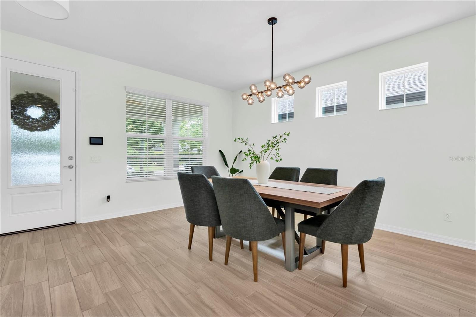 DINING ROOM WITH MODERN CHANDELIER
