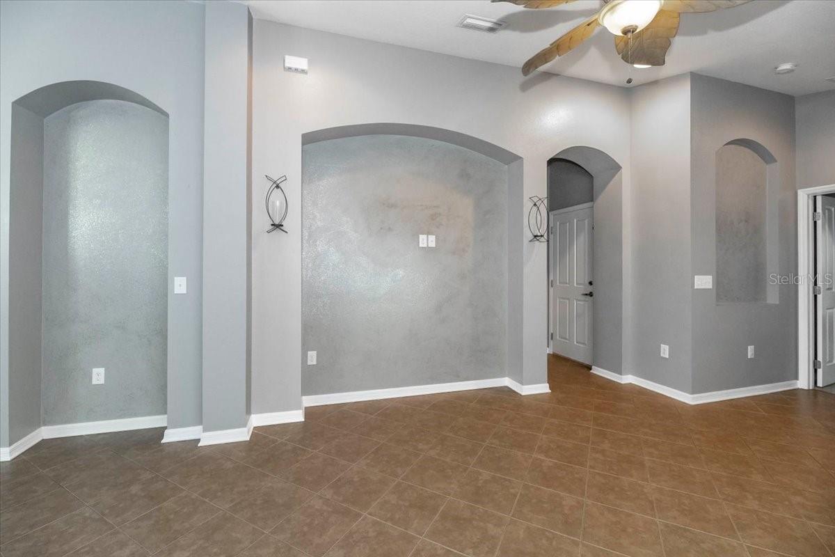 Living room and hall leading to the garage entry, 2nd bedroom and guest bath
