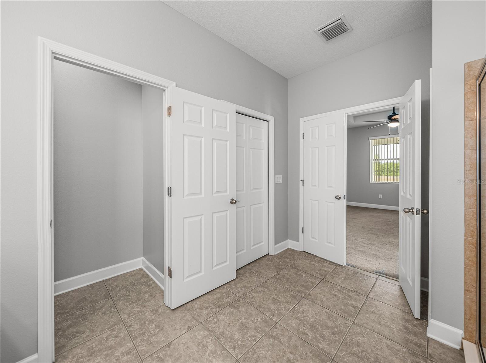 Primary bathroom has water closet and walk in closet