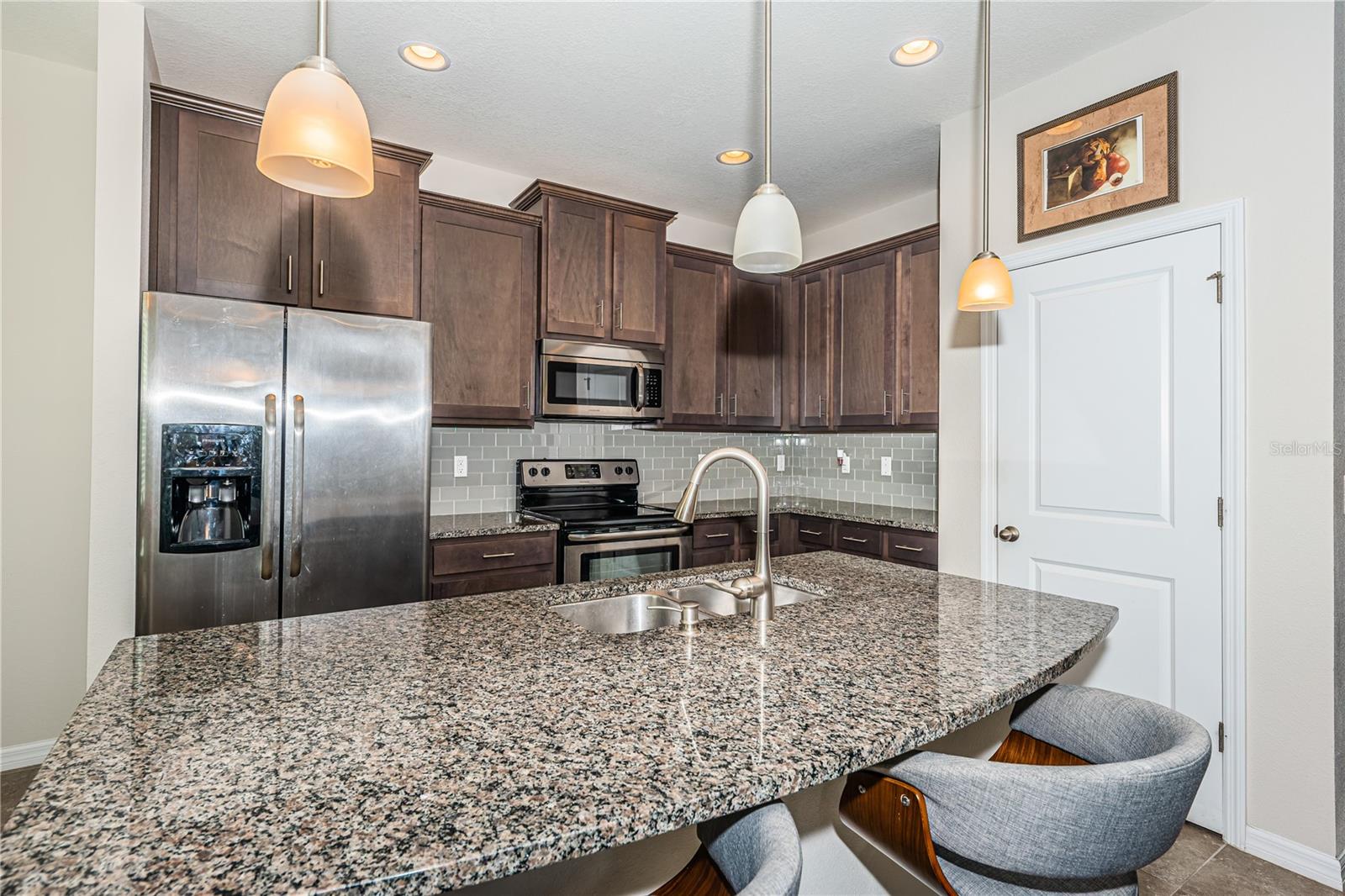 pantry and granite counters in the kitchen