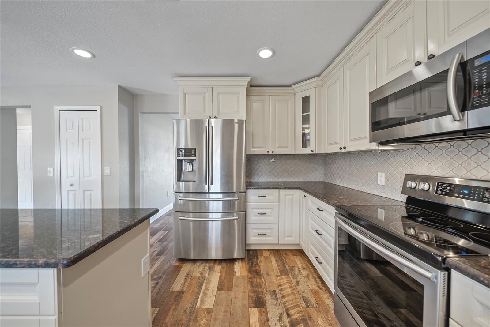 Alternative view of the kitchen.  Entry to dining room is between the pantry and refrigerator