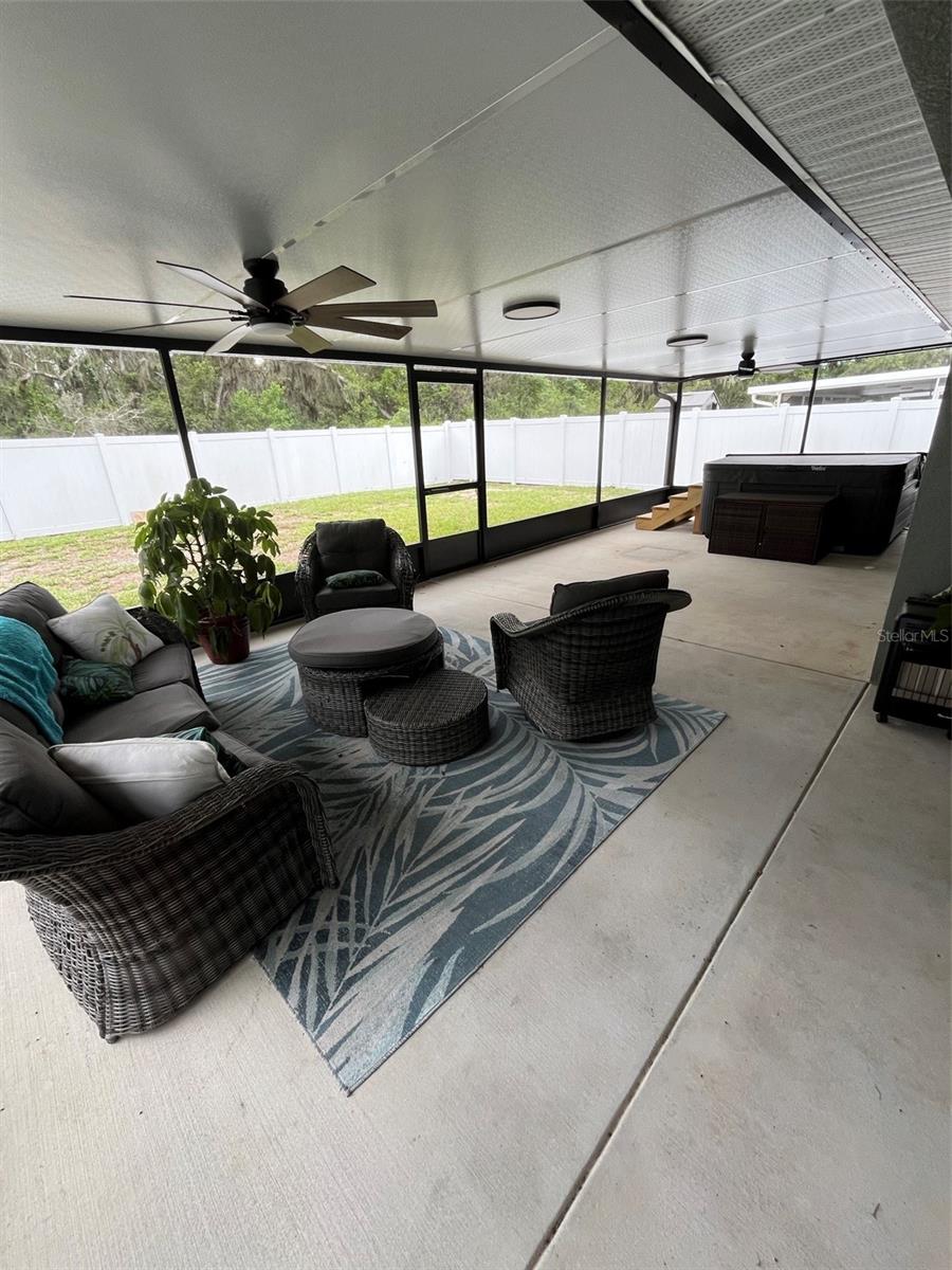 Back  screened in porch and hot tub