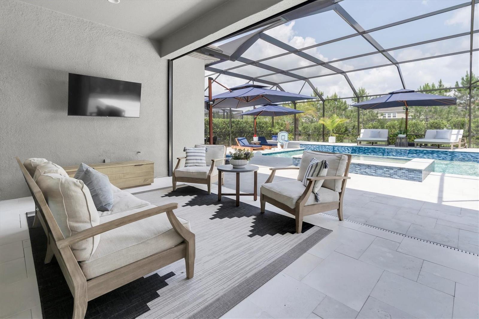 COVERED LANAI WITH MOTORIZED SUN SHADE THAT IS ALSO A MOVIE SCREEN!