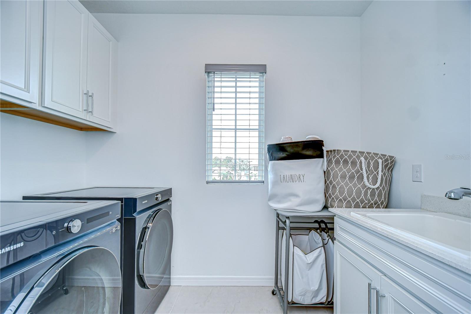 Upstairs laundry room with upgrades storage cabinets!
