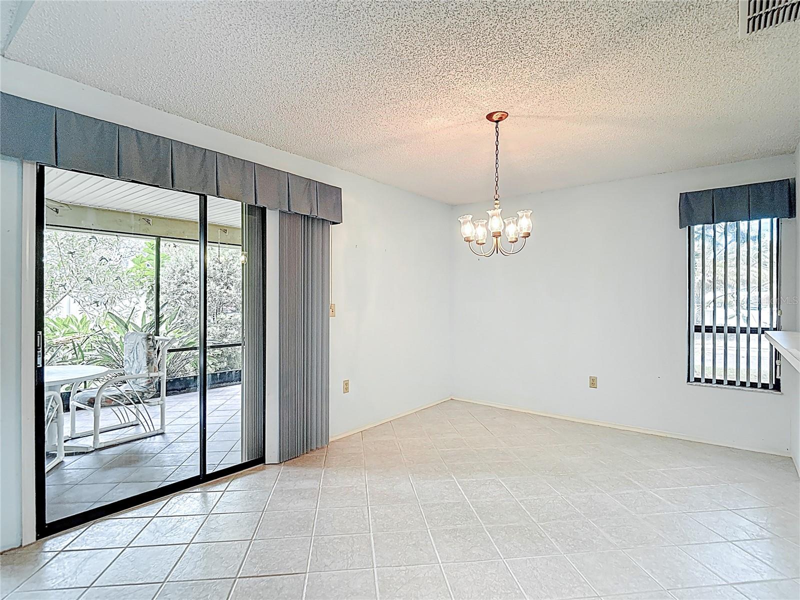 Dining area with sliding glass doors leading to scheened porch