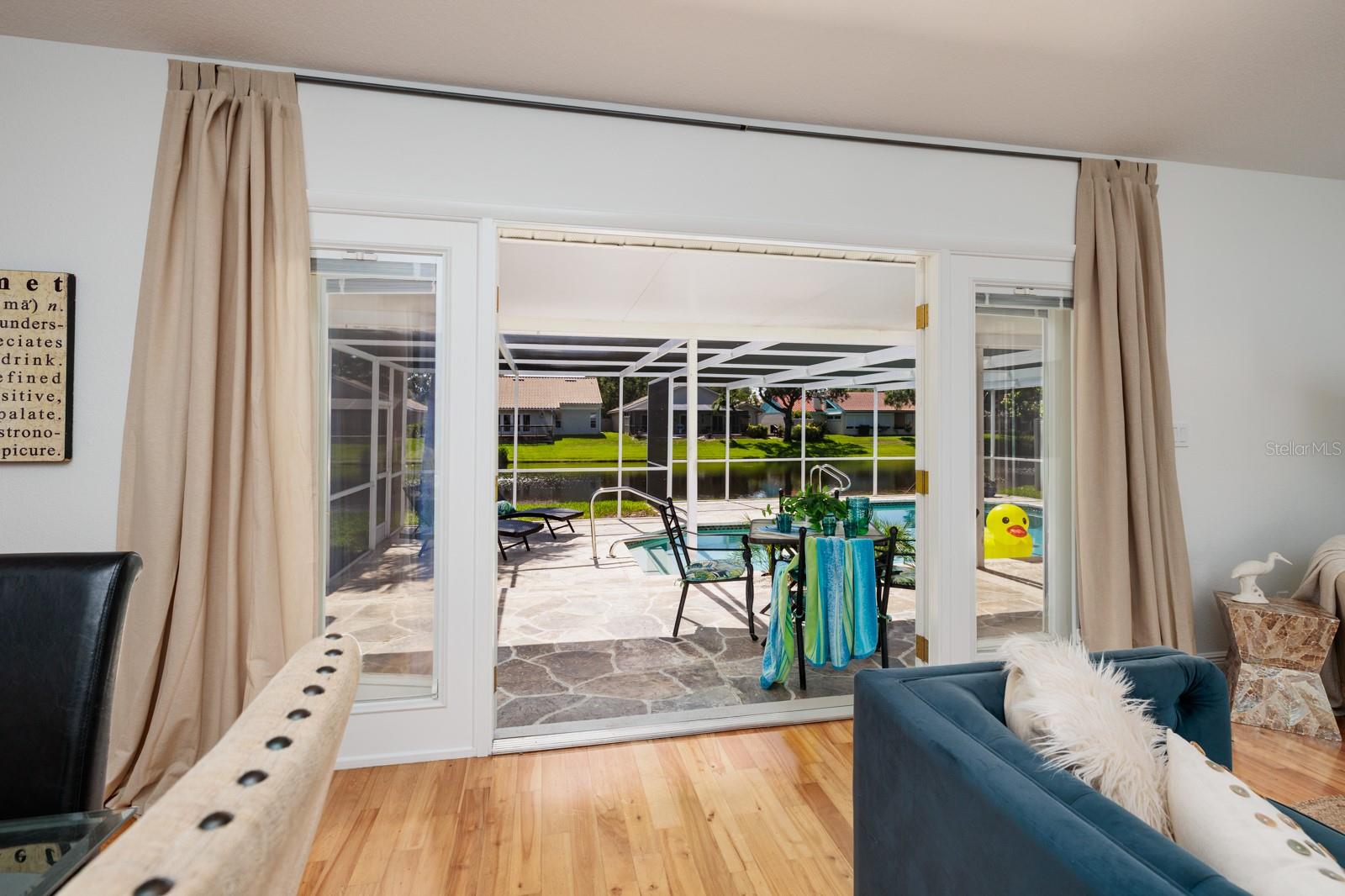 Your Light and Bright Open Floor Plan Surrounded By Pool/Lake /Nature Views!