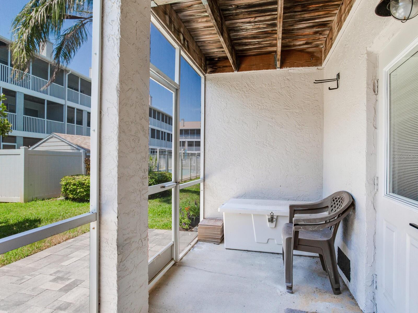 Screened in porch leading to back patio and heated pool