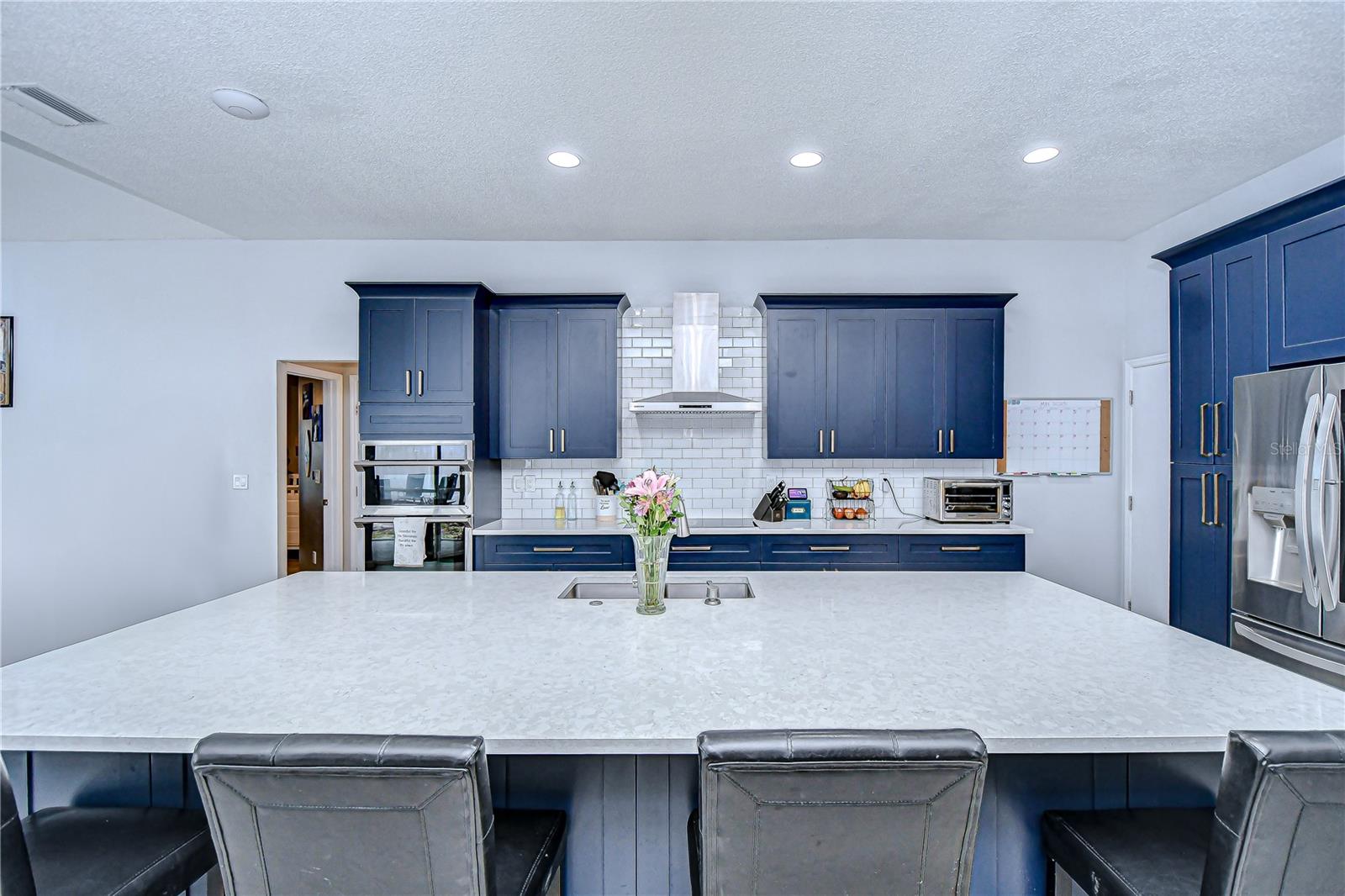 This oversized center island with seating and storage is absolutely stunning!