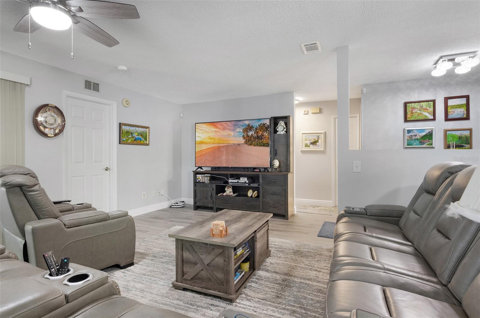 Living room with view of hallway to two guest bedrooms