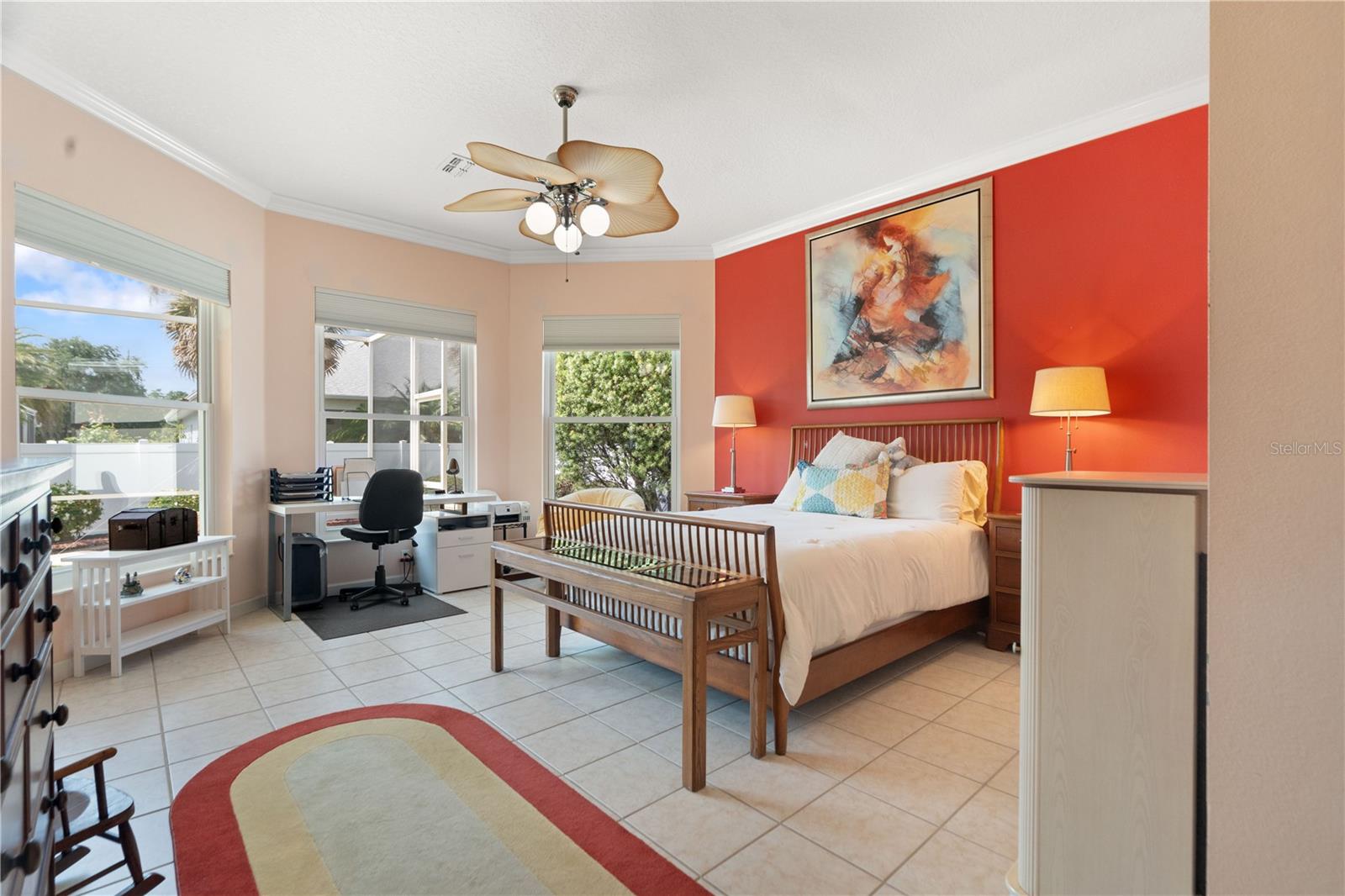 Primary bedroom has three large double pane windows that allows the beautiful sunshine into the room