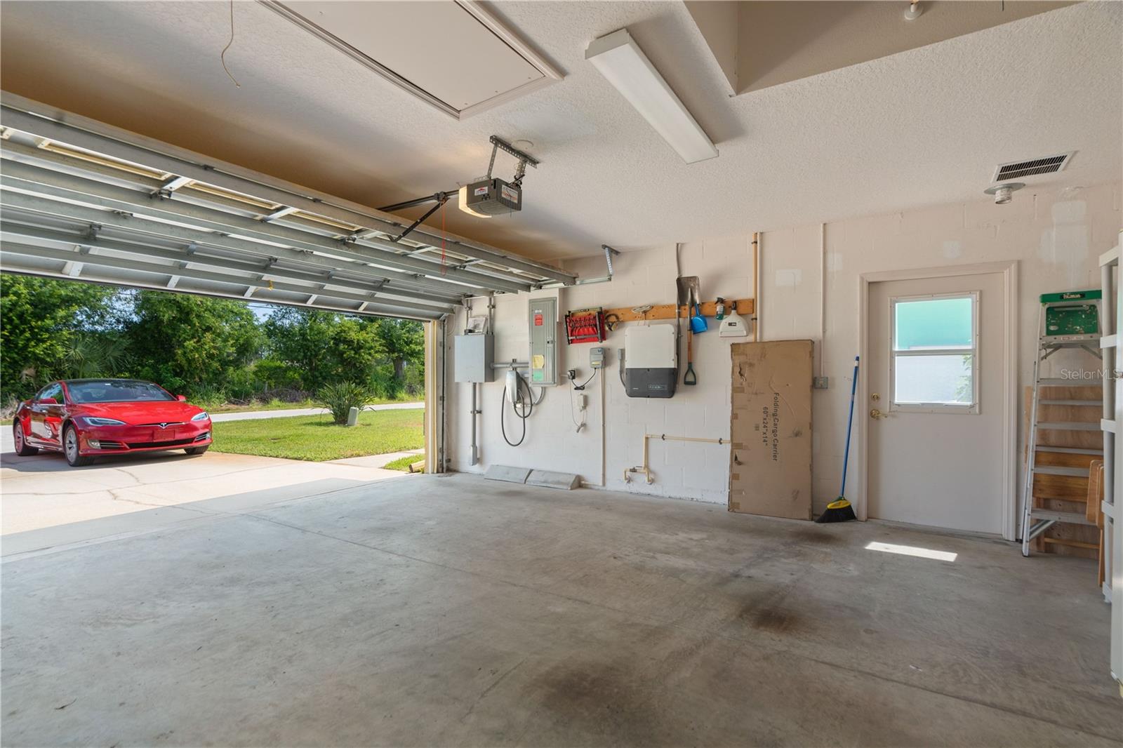 Tesla Charging Station will convey. Garage side door leads to where the generator is.