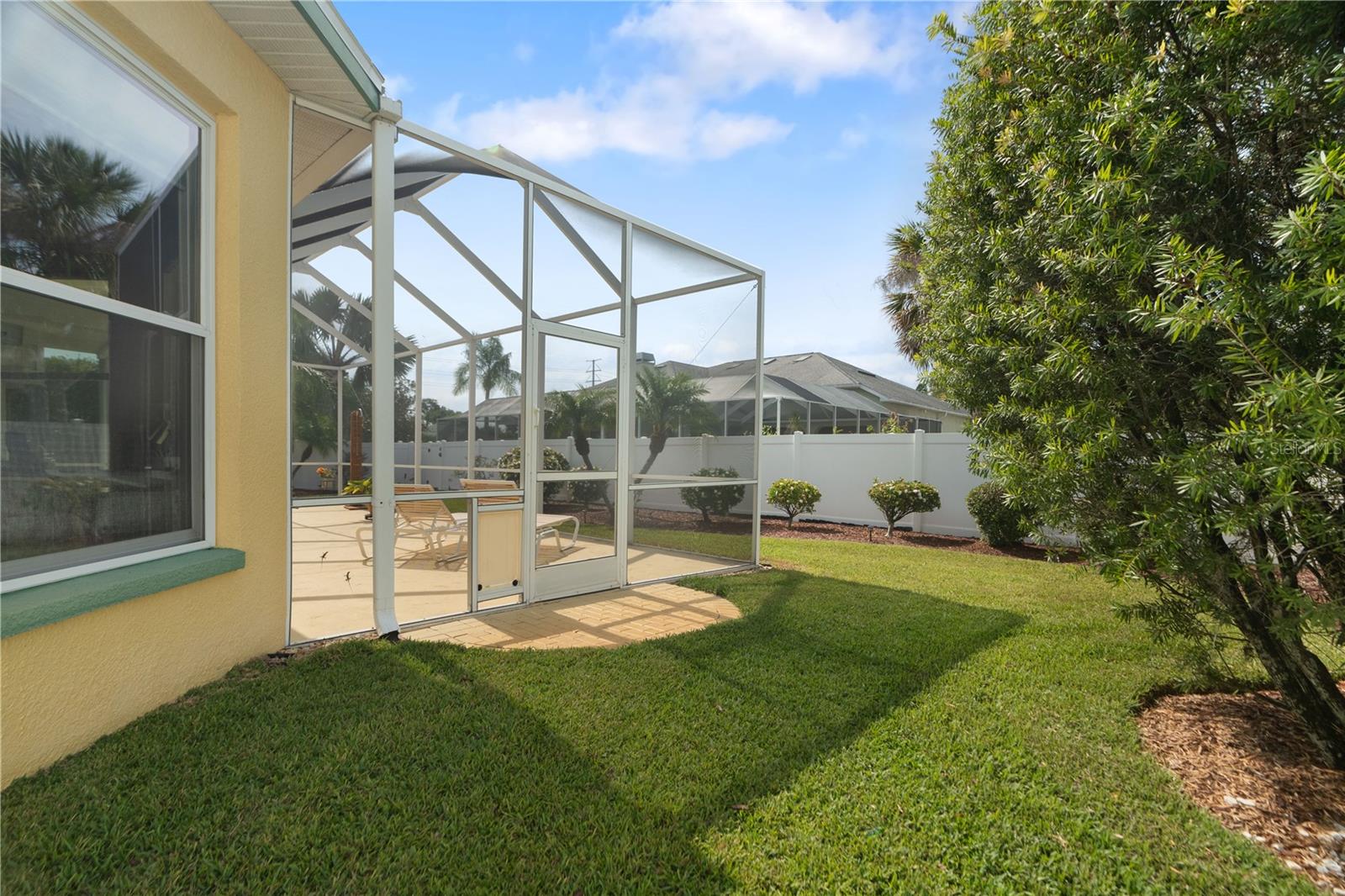 Screen enclosed lanai has screen doors at both the East and West side entering into the backyard.