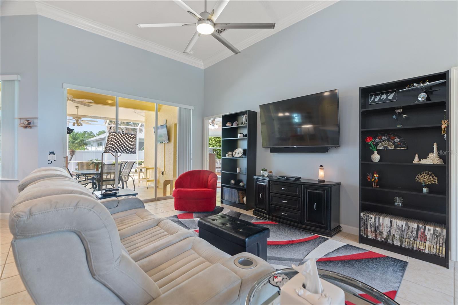 Living room has large sliding glass door that leads to the lanai.