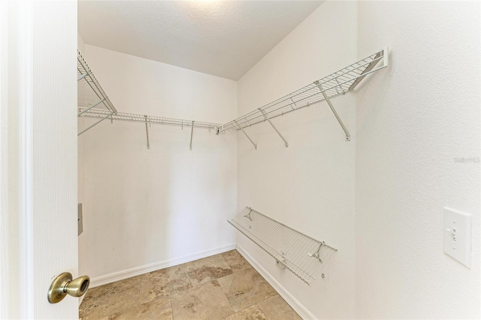 Primary bedroom walk-in closet