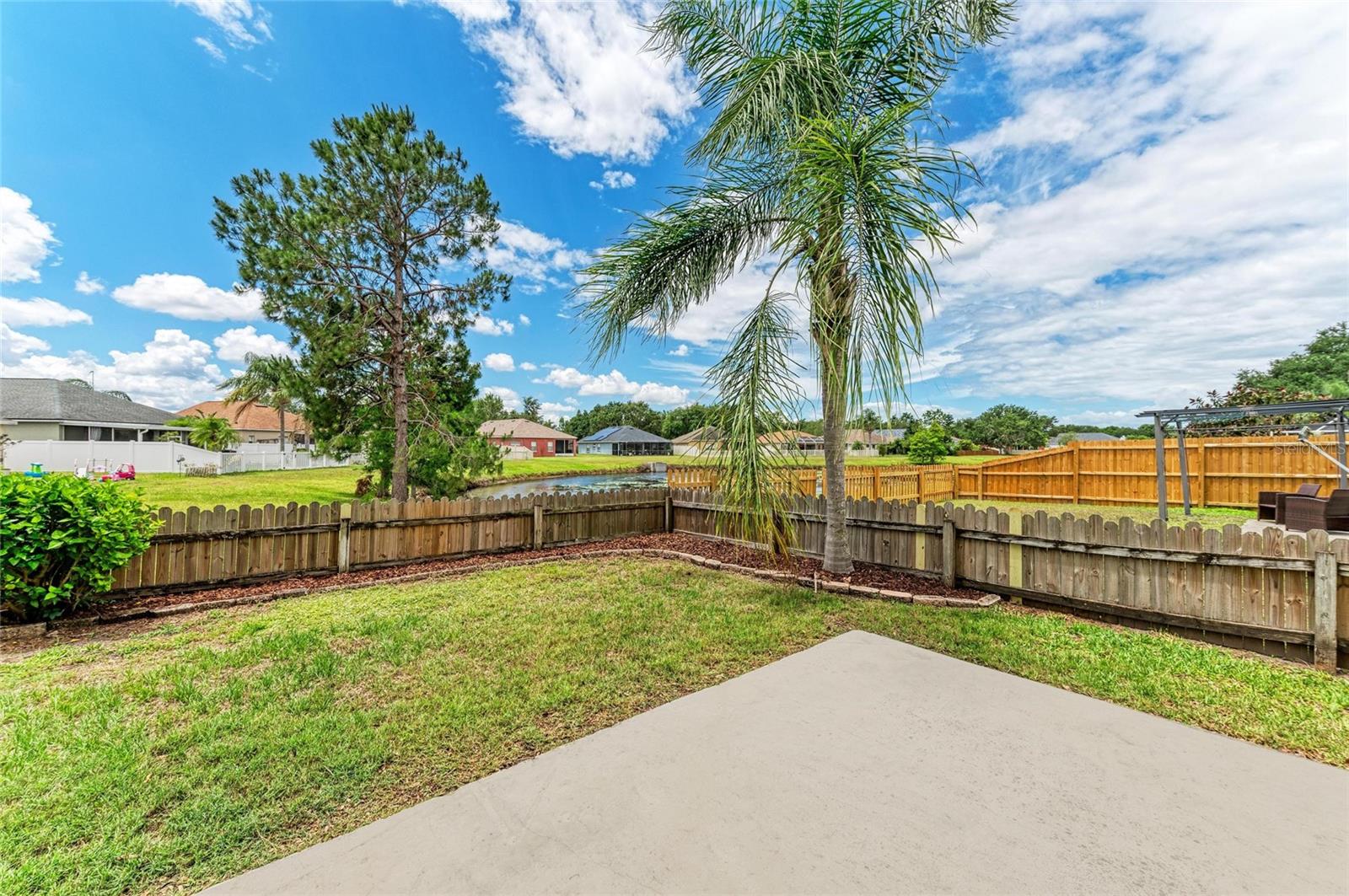 small fenced yard off back concrete patio