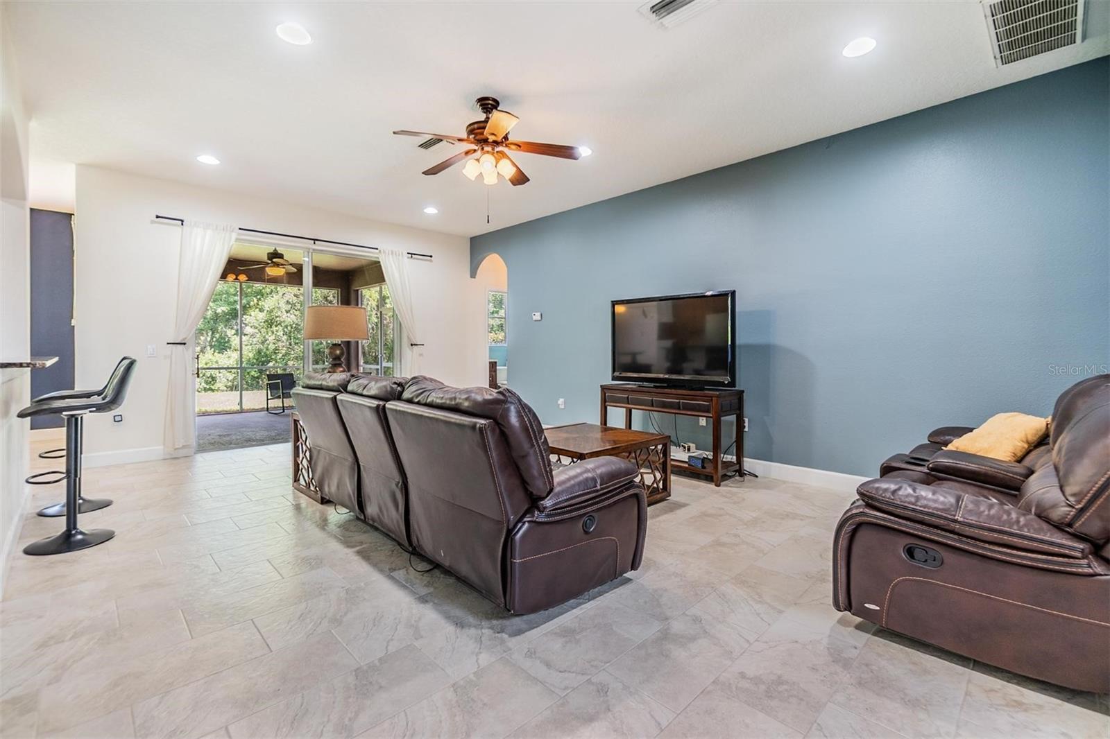 Living room with large sliding glass door to lanai