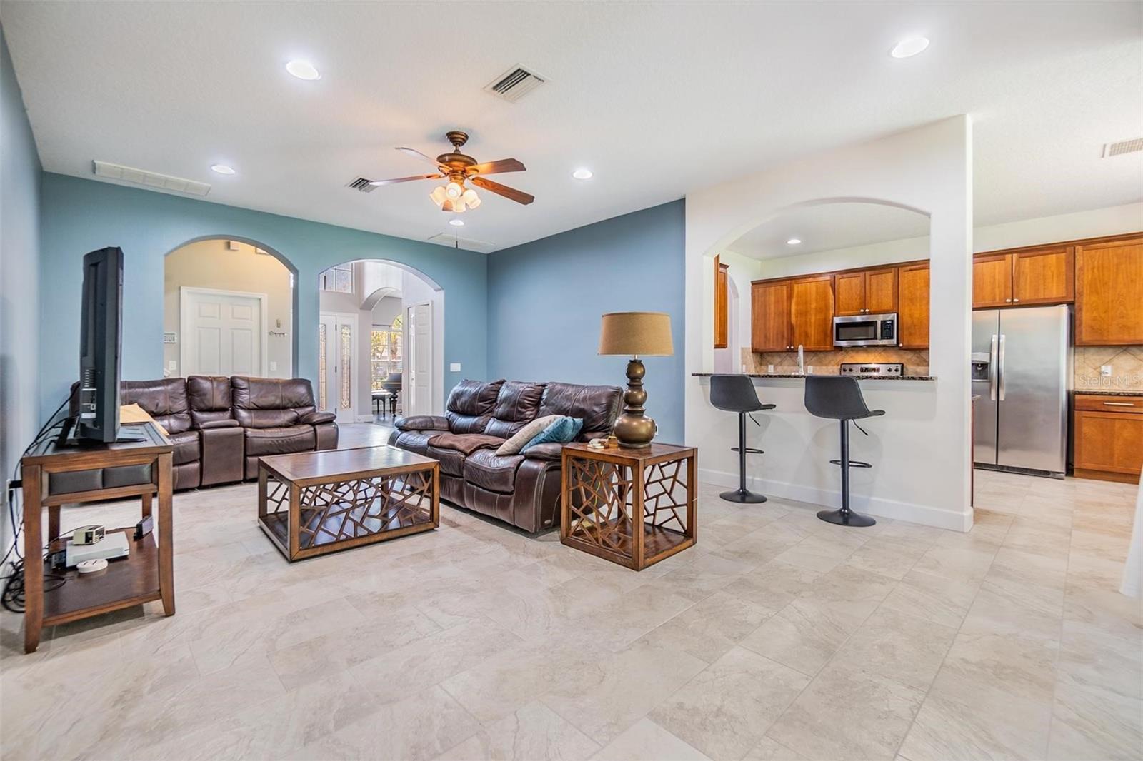 Living room view of kitchen - designer elements throughout like the arched doorways