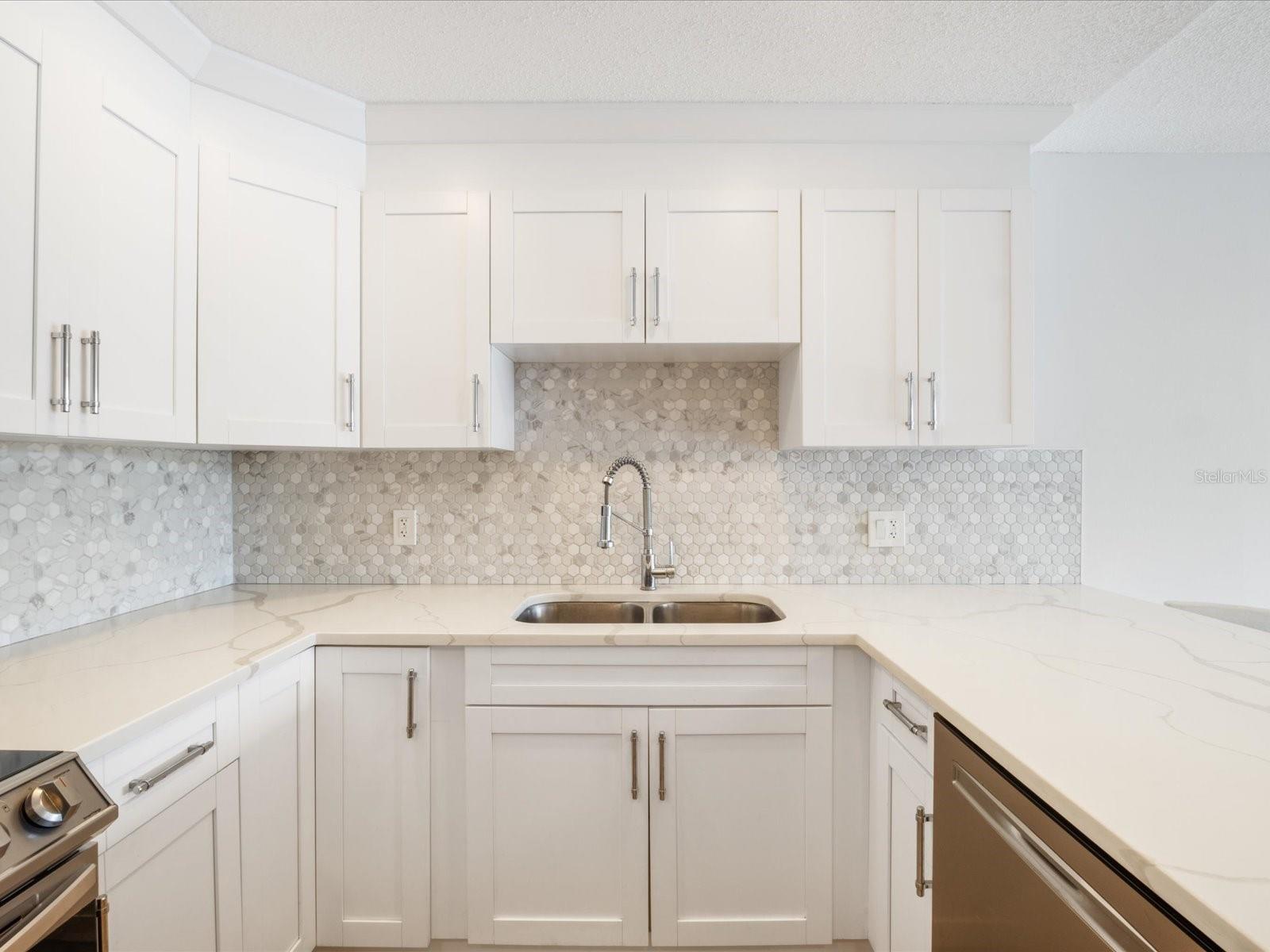 Beautiful Quartz countertops, stylish backsplash and shaker cabinets.