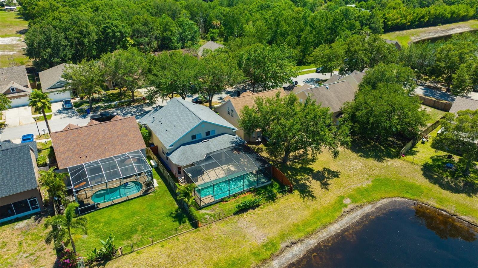 Aerial view of home, yard and pond.