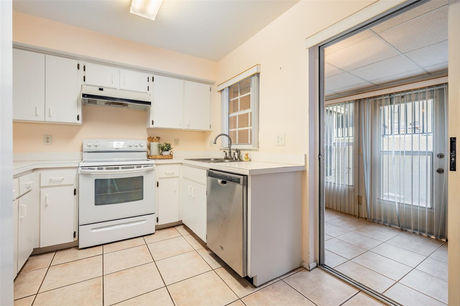 Off the kitchen is the enclosed patio with glass sliding doors